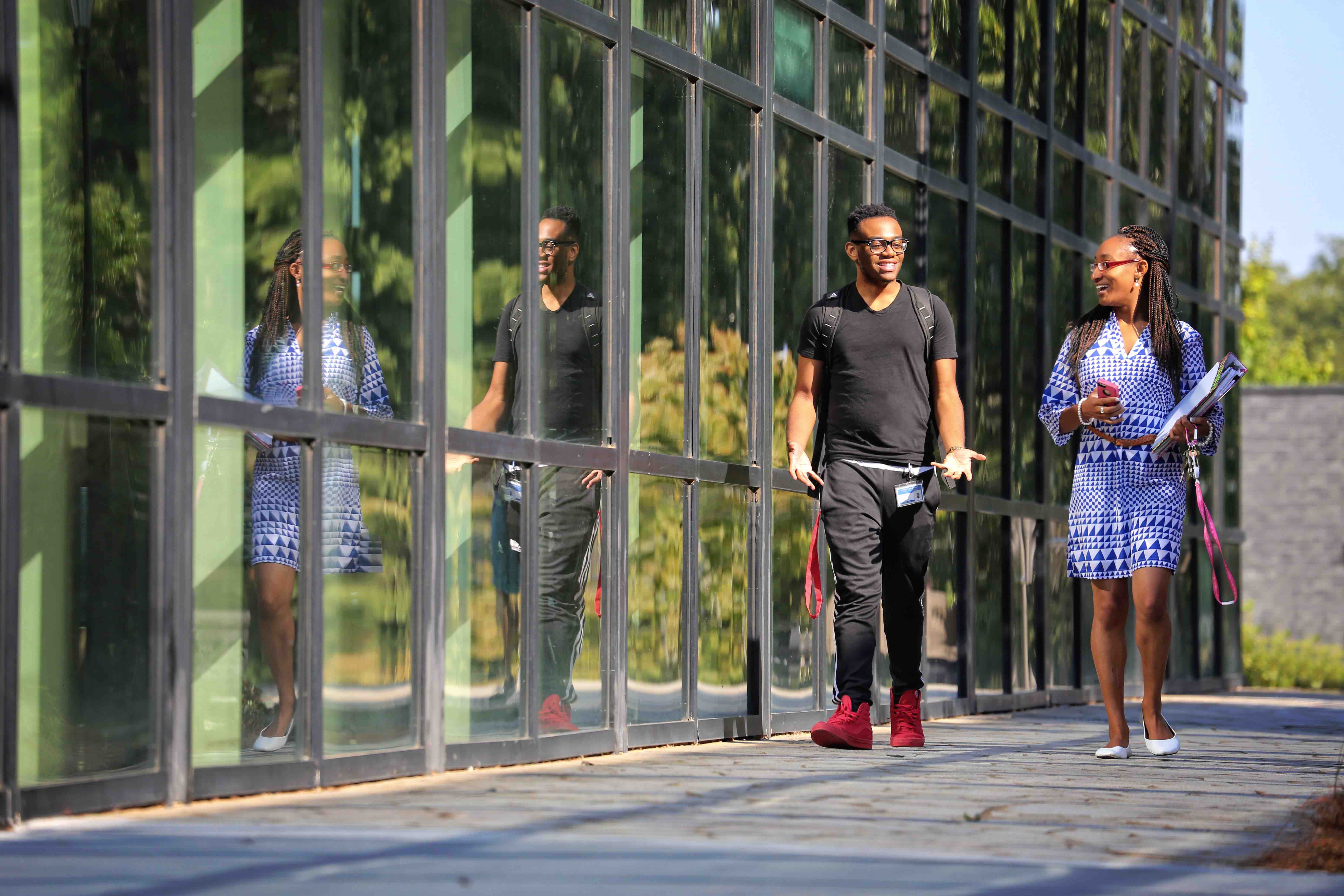 students-walking-glass-building.jpg
