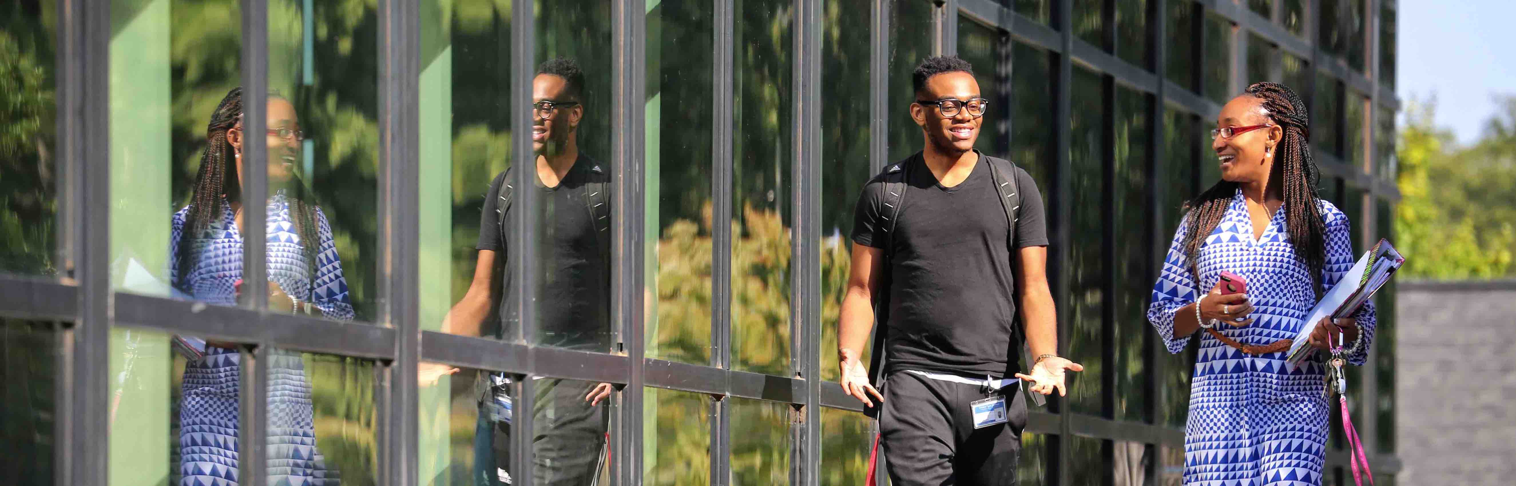 students-walking-glass-building.jpg